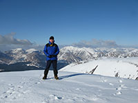 On the summit of Glas Bheinn Mhor, peaks of Glen Etive and Glencoe behind  