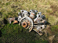 One of the engines from the B-26 Invader lying partially submerged in boggy ground